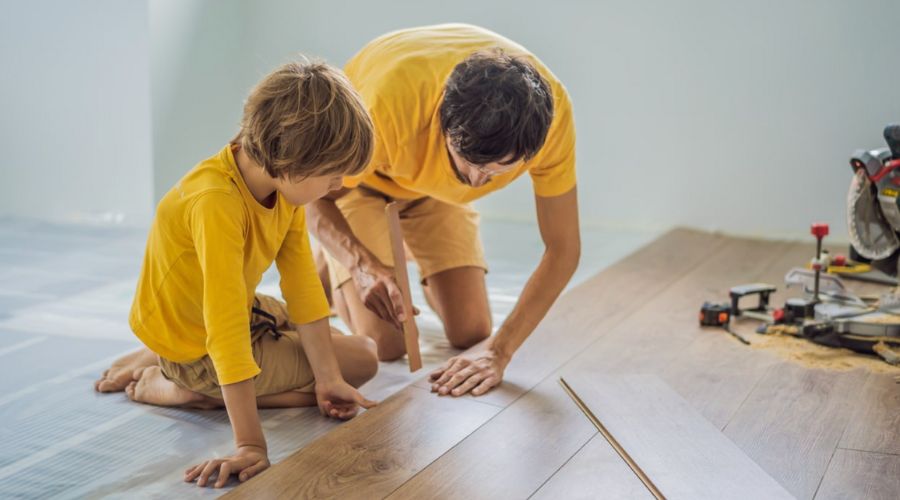 father and son installing new flooring