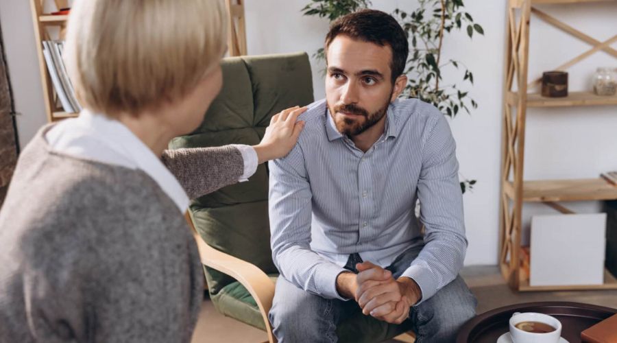 stressed man talking with financial counselor