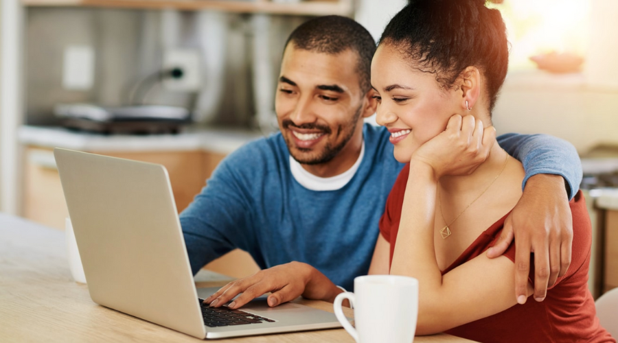 couple working on finances on their laptop
