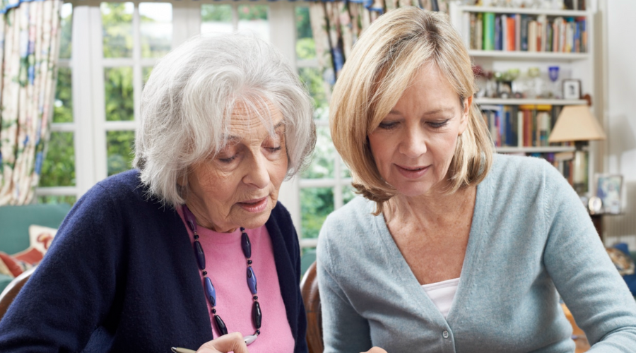 daughter helping elderly mother with finances