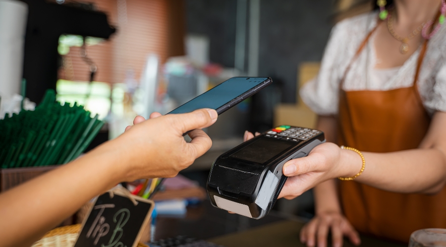 person paying with card via smartphone